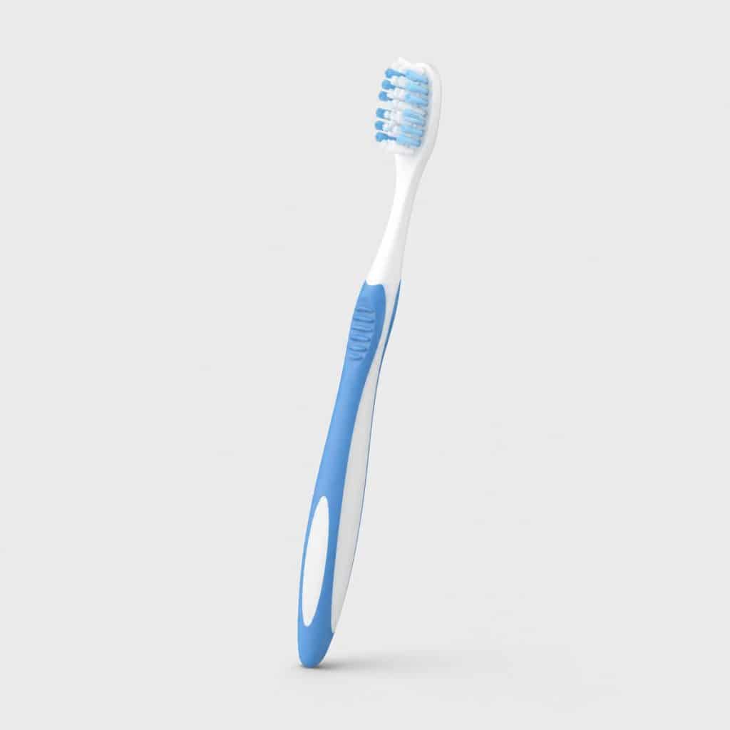 Brosse à dent souple posée sur fond neutre